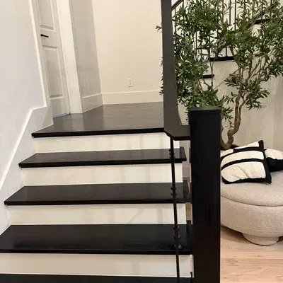 Dark stained stair treads with black metal railing — Frisco, TX | Goldstar Renovations