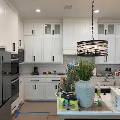 White shaker kitchen remodel with black hardware and pendant lighting — Prosper, TX